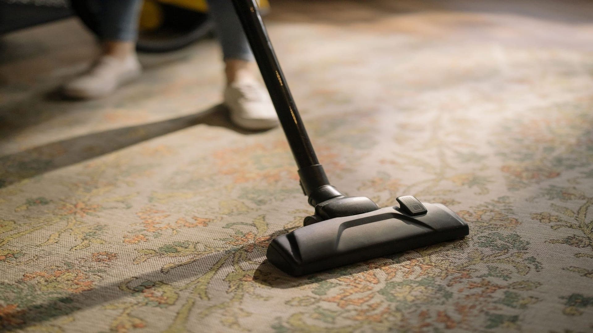 Vacuum cleaner working across a patterned rug — illustrative of carpet cleaning across all of Sydney