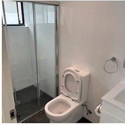 Bathroom toilet and glass shower after an end-of-lease clean